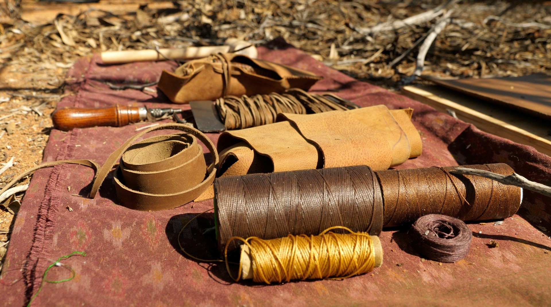 Leatherworking tools laid out on canvas